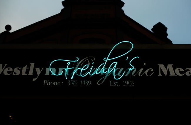 Blue neon Freida sign.