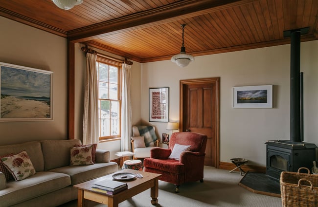 Lounge area with log burner at French Bay House, Akaroa Canterbury.