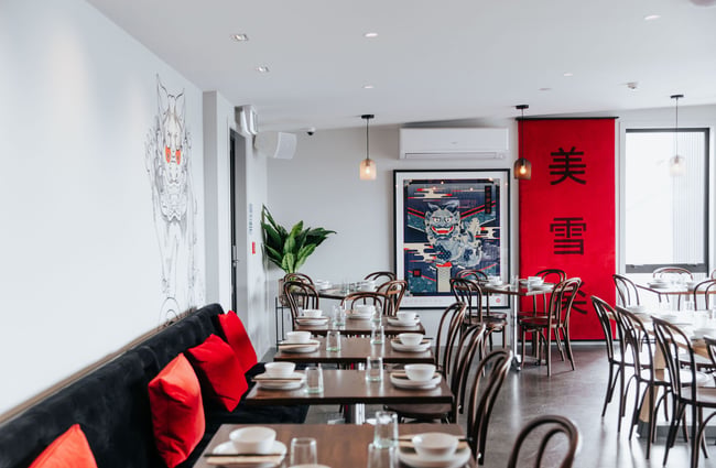 A dragon print on a wall inside the restaurant.