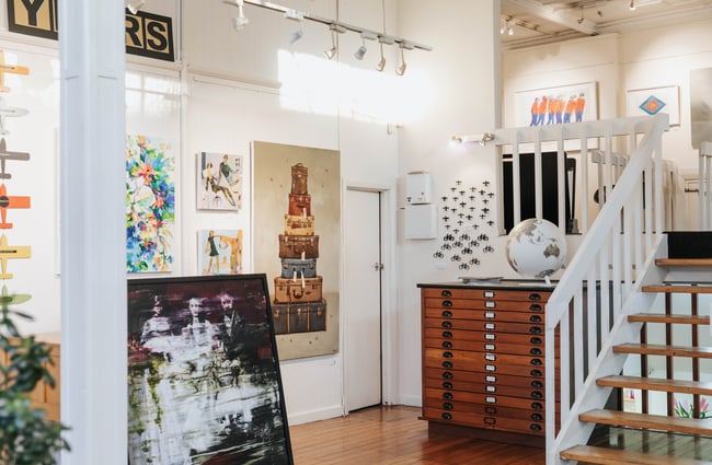 Inside the gallery with art on the walls.