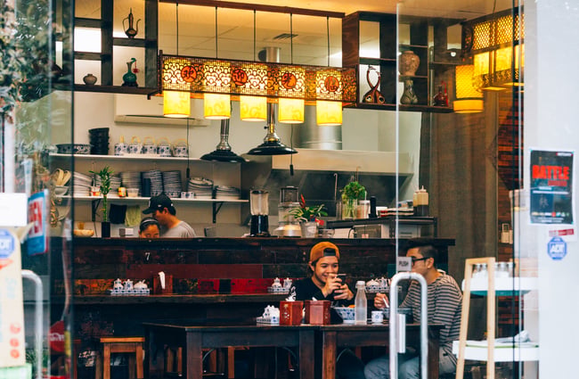 Two customers at a table in Garden Place Noodle Bar, Hamilton.