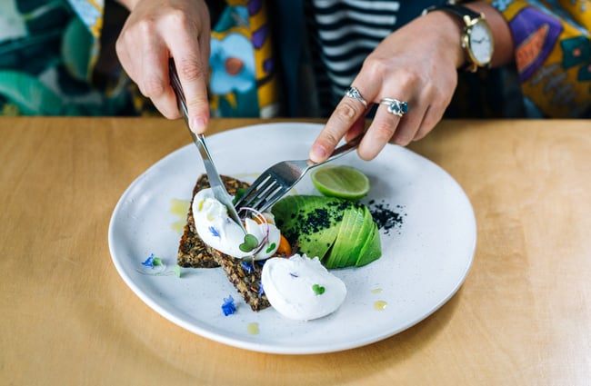 Customer cuts into meal at Gather Foodhouse, Hamilton.