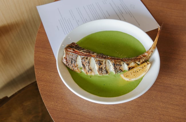 Close up of a cooked fish in a green soup at Gatherings in Christchurch.