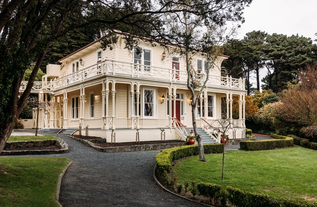 Gear Homestead building exterior set amongst lush gardens