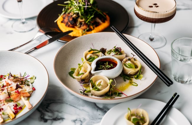 Flatlay of food dishes plus an espresso martini at Gear Homestead.