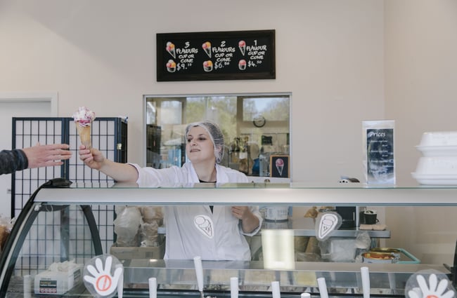 Woman handing over a gelato at Gelato Lab in Christchurch.