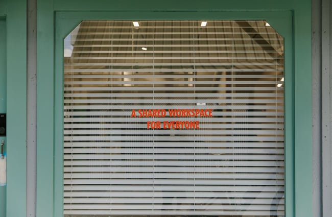The green door with window shades for the General Service shared workspace.