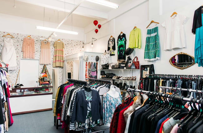 Lots of clothes on display on racks inside Georgie Girl.