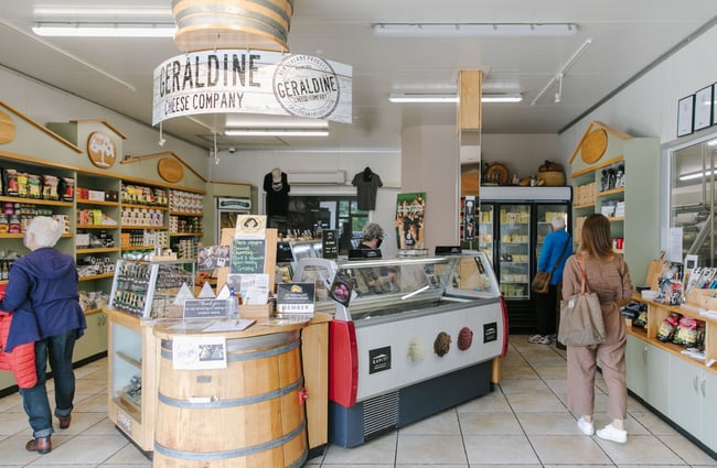 Customers browsing inside Geraldine Cheese Company store.