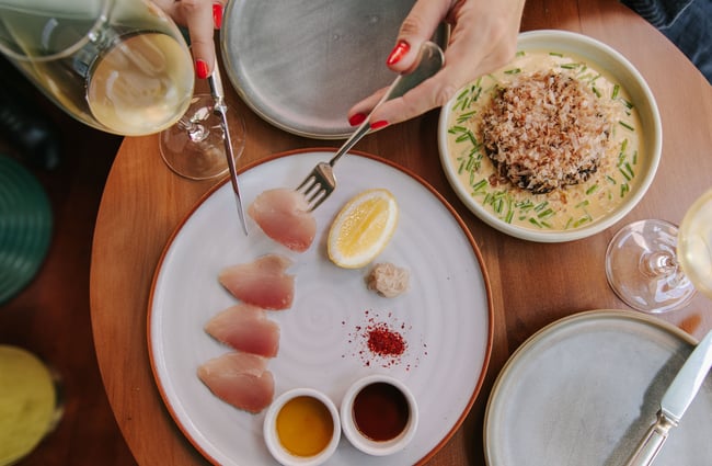 A woman eating sashimi at gin gin in Christchurch.
