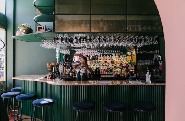 Woman pouring a cocktail at gin gin in Christchurch.