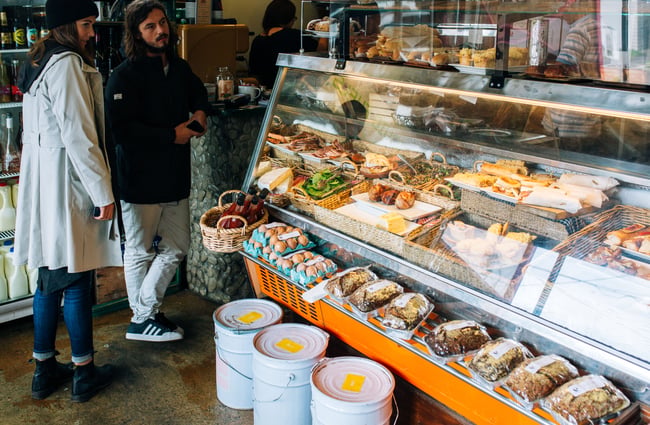 A man and a woman waiting to be served at the counter inside Gispy Kitchen cafe Wellington.