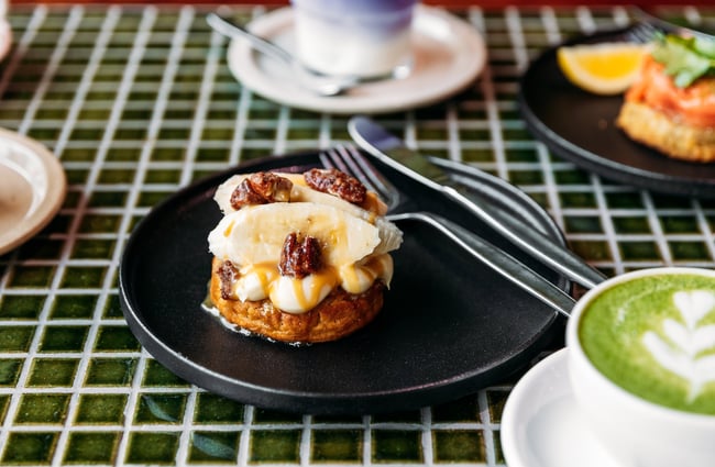 Housemade crumpet topped with banana, maple and pecans