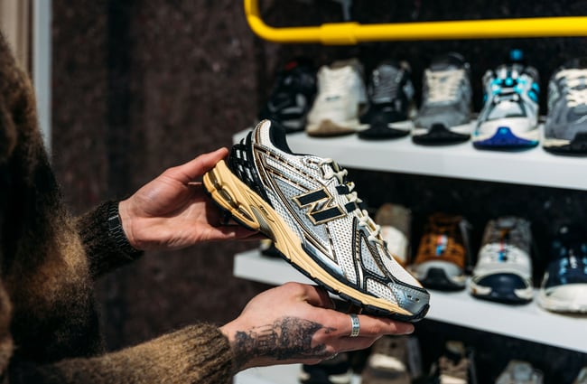 Two hands holding a sneaker.