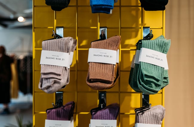 A close up of colourful socks on display.