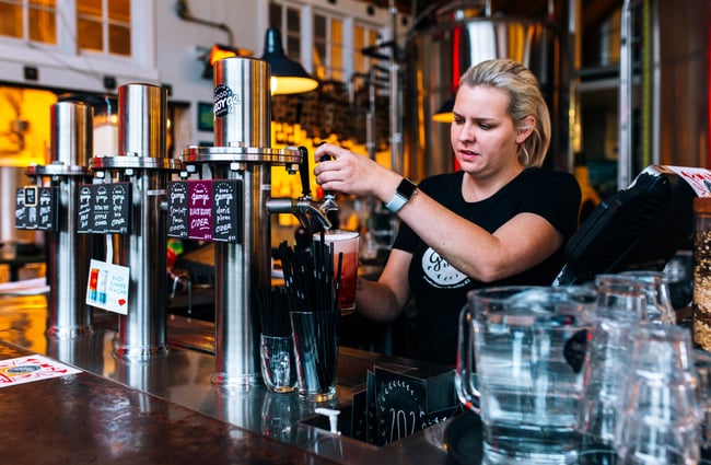 Bartender pours a pint at Good George Dining Hall, Hamilton.