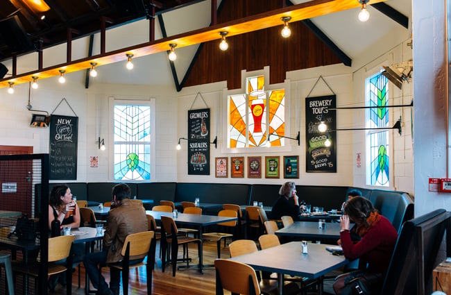 Customers sitting at tables at Good George Dining Hall, Hamilton.