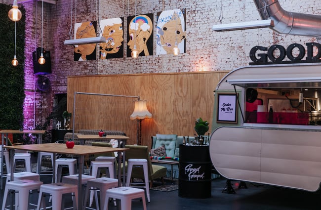 A caravan and seats inside the bar.