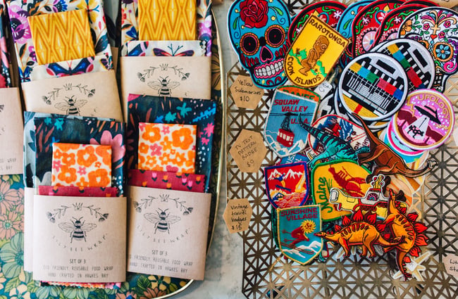Beeswax wrtaps and fabric badges laid on a table at Good Housekeeping Wellington shop, New Zealand.