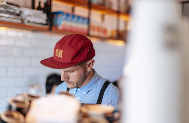 A man working behind the counter.
