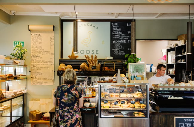 Customer ordering at the counter at Goose Bakery.