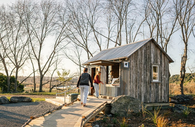 Customers walk up to small cottage building at Gorge Quarter.