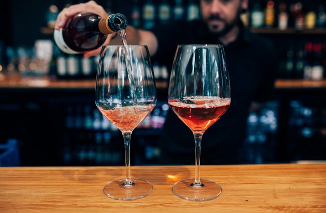 Barman pouring two rosés.
