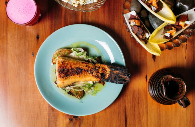 A cooked fish tail on a plate.