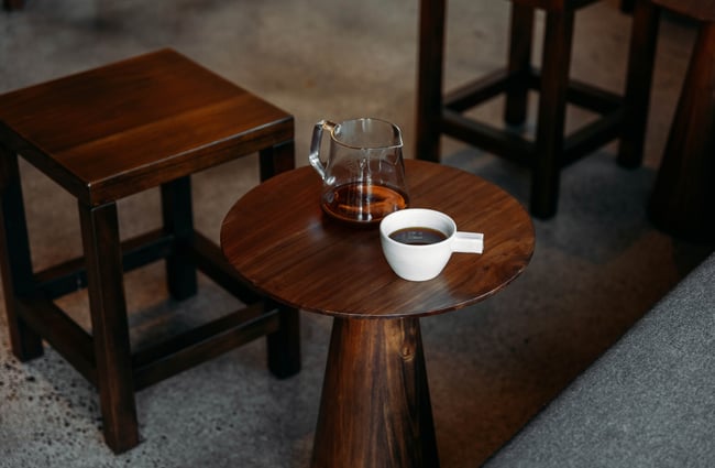 Coffee on a small wooden table.