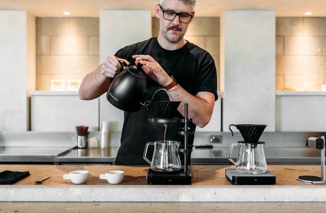 A man pouring filter coffee.