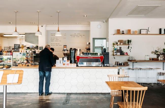 A customer paying at the counter at Grey Street Kitchen.