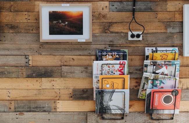 Magazines on display on a wall.