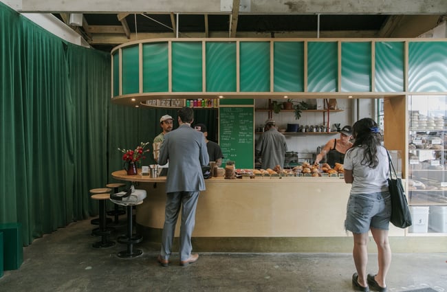 A customer being served at the counter at Grizzly Baked Goods in The Welder.