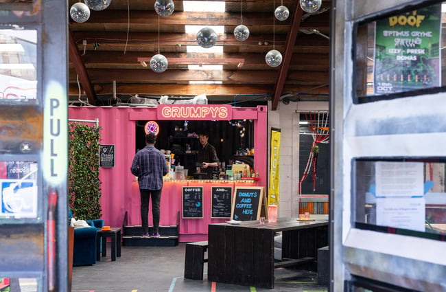 Customer standing at the entrance to the container ordering at Grumpys.