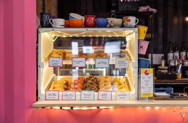 Donuts in the cabinet in the container at Grumpys.