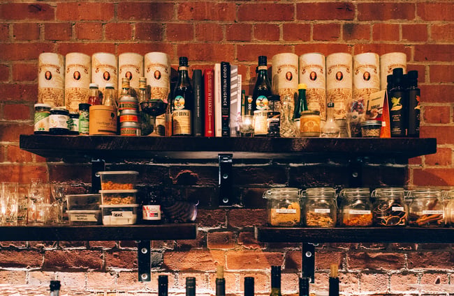 Alcohol and glasses on shelves.