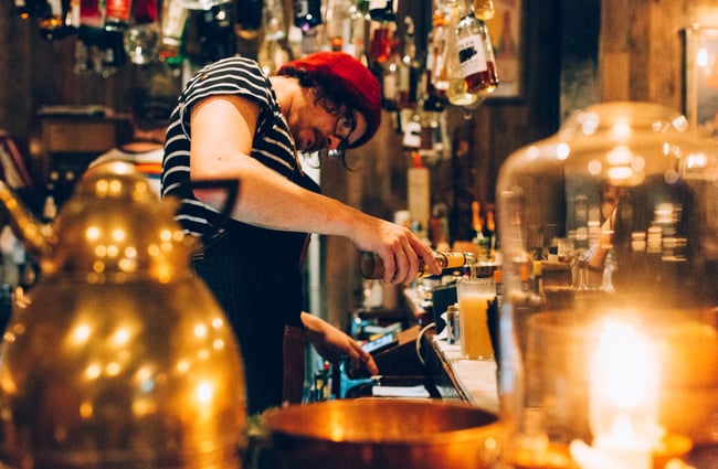 A man pouring a beer.