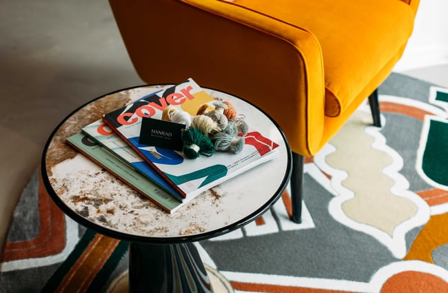 A close up of balls of wall sitting on top of rug magazines.