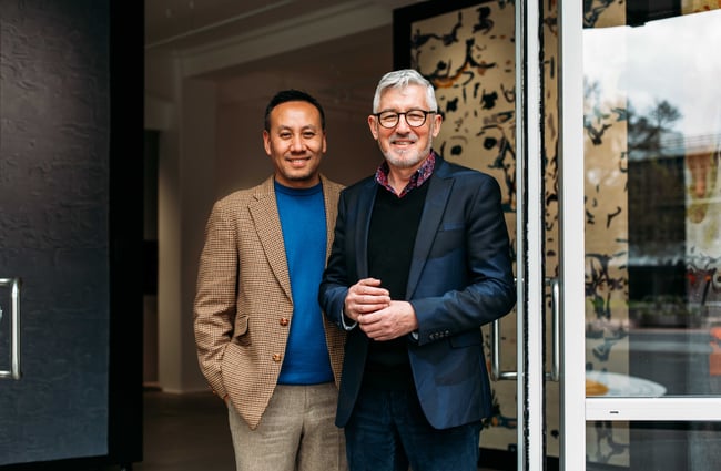 The two owners of Hanrad Bespoke Rugs smiling to camera.