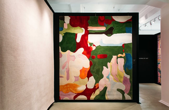 A beautiful multi coloured rug hanging up.