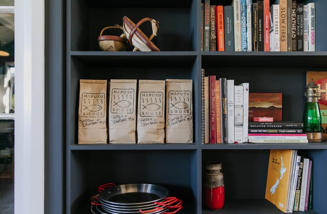 Random objects on a bookcase shelves at Hapuku Kitchen.