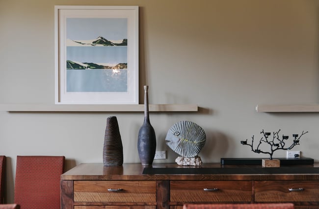 Artwork and sculptures on a side table at Hapuku Lodge.