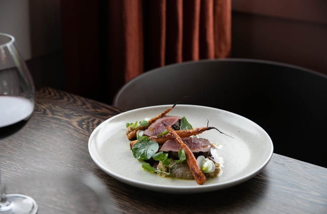 Beef dish with carrots on table at Hapuku Lodge.