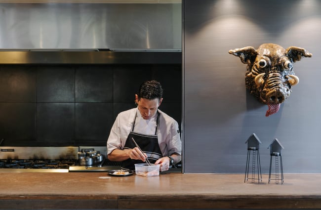 Chef preparing a dish in the Hapuku Lodge kitchen.