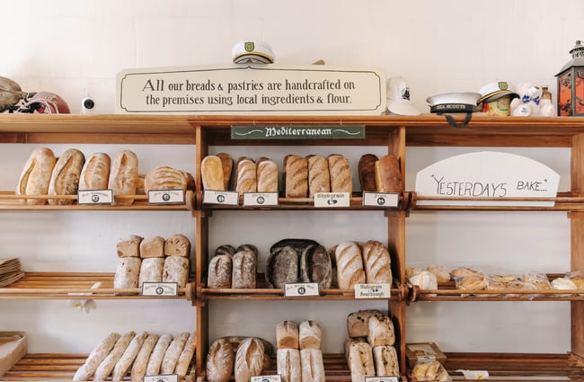Fresh bread lined up on bakery shelves at Deja Moo & Harbour Street Bakery in Ōamaru.