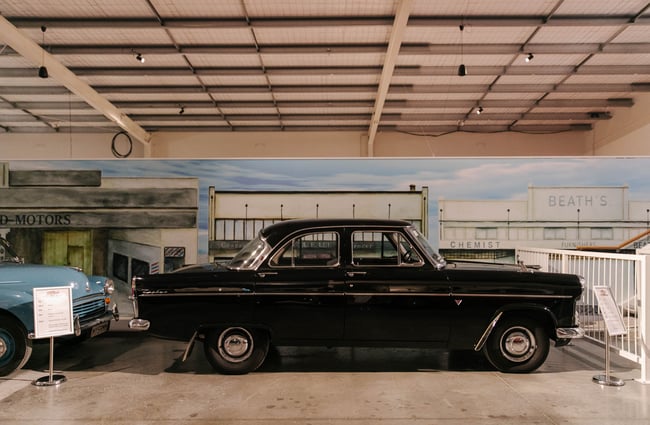 Side view of old black car at Harmon's Motor Museum.