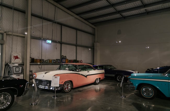 View of pink and white classic car at Harmon's Motor Museum.