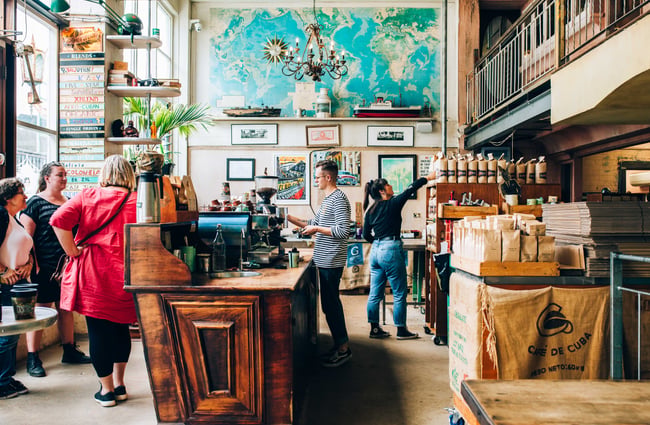 Customers standing waiting for coffees.