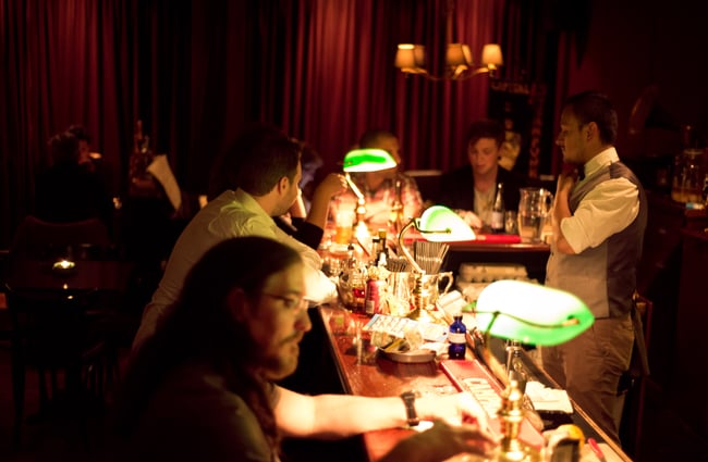 Green lamps on bar counter.