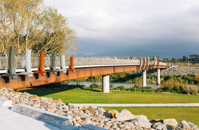 The He Ara Kotahi Bridge with fog covered mountains in the background.